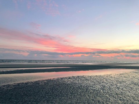 Pink sunset over a sandy beach in summer, Rindby Strand, Fanoe, Jutland, Denmark