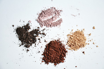 different colors piles of eyeshadows on white background 