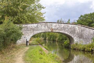 Fototapeta na wymiar Arch bridge on the Trent and Mersey canal in Cheshire England UK