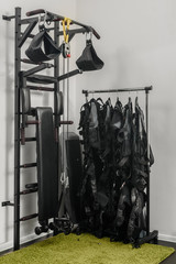 Electrical muscle stimulation vests hanging on rack in gym