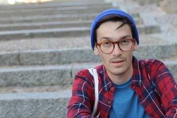 Puzzled looking young man looking at camera