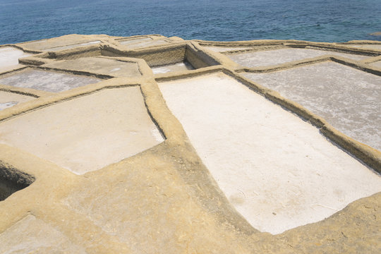 Traditional Maltese salt evaporation in city Zebbug, Gozo / Malta. Square salt pans is former method of salt production on site next battery Qolla l-Bajda.