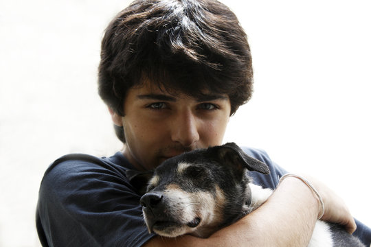Man cuddling his dog