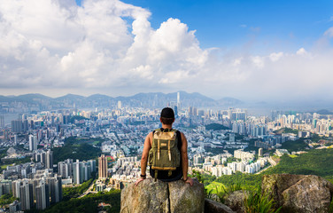 Man enjoying Hong Kong view from the Lion rock - obrazy, fototapety, plakaty