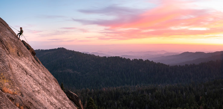 Woman abseiling Down a granite Cliff at Sunset, Sequoia National Park, California, United States