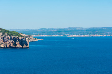 Fototapeta na wymiar Landscape of sardinian coast with city of alghero in the background