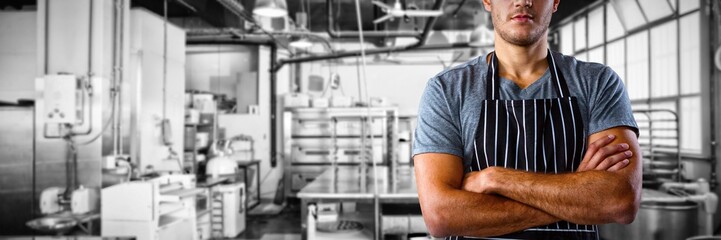 Composite image of male waiter standing with arms crossed