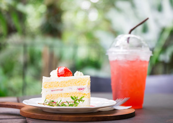 closeup of delicious strawberry cake with leaf and fruit on top