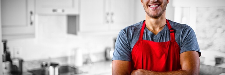 Composite image of male waiter standing with arms crossed