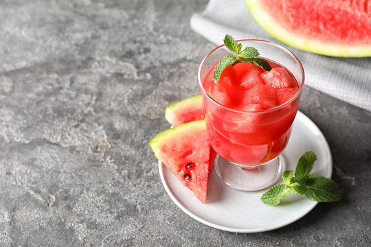 Tasty summer watermelon drink in glass and space for text on table