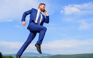 Keep going towards your goal. Businessman formal suit jump while call smartphone sky background....