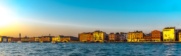 VENICE, ITALY, SUNSET - A panoramic view of the famous lagoon on the island of Venice, in the evening with a blue cloudless sky in the evening light.