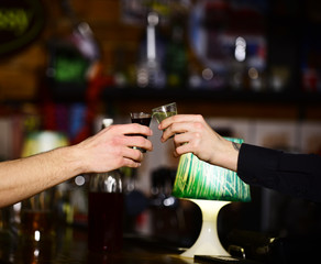 Male hands cheer with glasses of shot or liqueur.