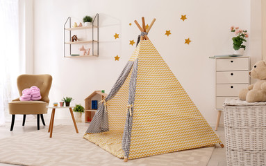 Fototapeta na wymiar Cozy kids room interior with play tent and toys
