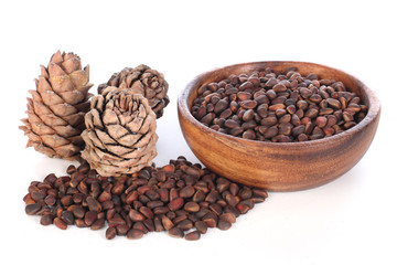 Siberian cedar cones with nuts on a white background.