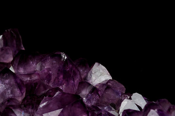 part of mineral purple Amethyst crystal quartz texture background with black isolated background...