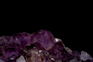 part of mineral purple Amethyst crystal quartz texture background with black isolated background and have some space for write wording