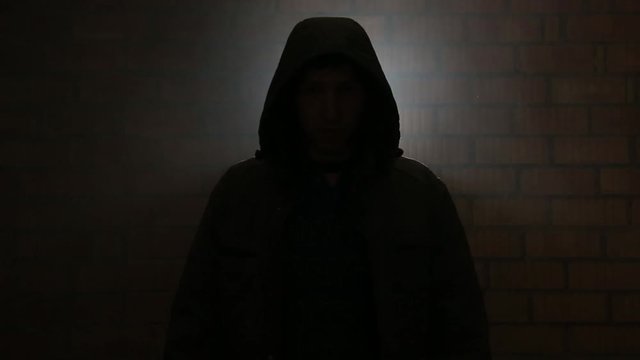Serial killer in the dark breathing heavily waiting for the victim