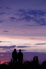 Fototapeta na wymiar Silhouette of two men at sunset
