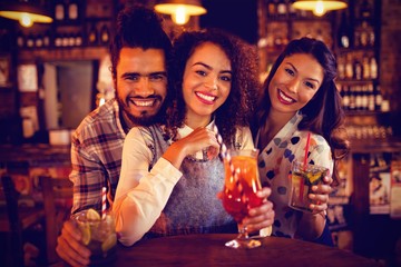 Portrait of young friends having drinks