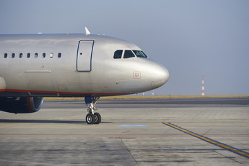 Obraz premium Traffic at the airport. Airplane is taxiing to the runway.