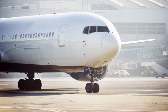 Traffic At The Airport. Airplane Is Taxiing To The Runway.