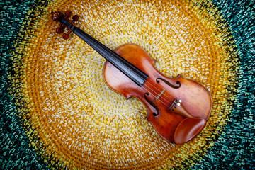 violin on a colored knitted rug