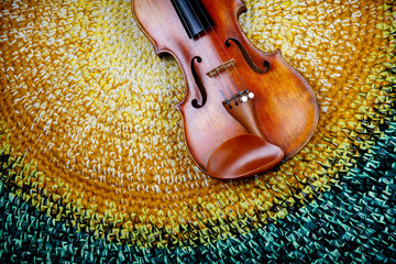 violin on a colored knitted rug