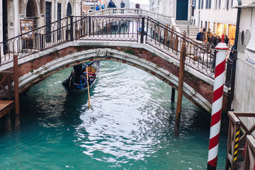 Fototapeta na wymiar Gondolas on lateral narrow Canal, Venice, Italy.
