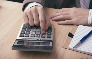 business accountant with calculator for calculate financial on office table. concept planning budget and audit.