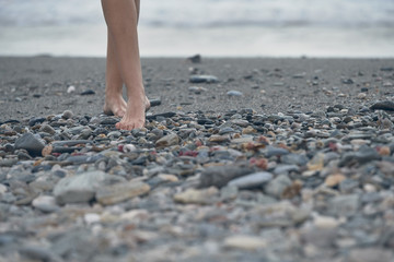 Photograph of the legs of a girl walking on the beach. Granada, Spain