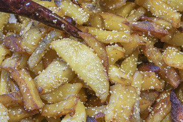 Fried potato pieces with fried red chilly