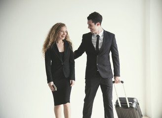 Young businesswoman and businessman with luggage talking in room airport. concept business travel trip.