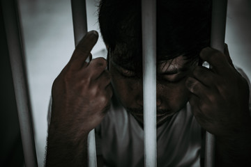 Hands of men desperate to catch the iron prison,prisoner concept,thailand people,Hope to be free.