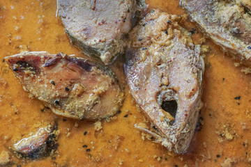 Hilsa fish pieces on a plate.