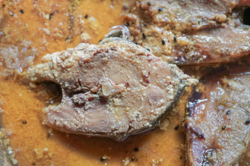 Hilsa fish pieces on a plate.