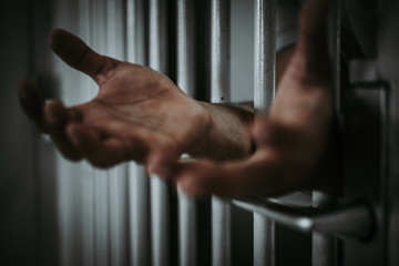 Hands of men desperate to catch the iron prison,prisoner concept,thailand people,Hope to be free.