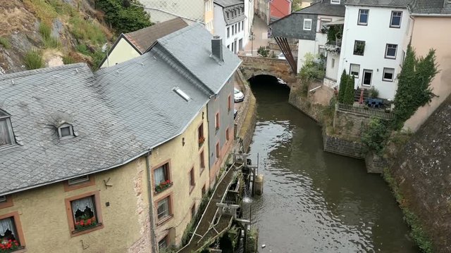 Cityscape of Saarburg with its historical old town part and Leuk River flowing into the city.