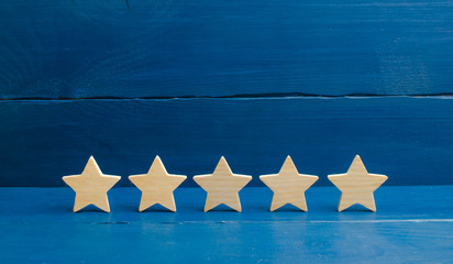he rating of the hotel, restaurant, mobile application.Five stars on a blue background. The concept...