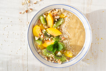 Smoothie with peach, kiwi, nuts, sesame 