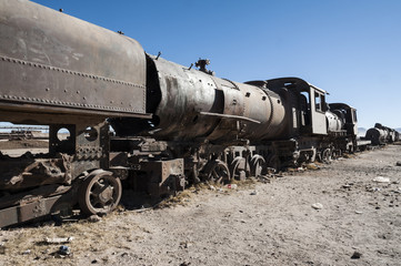 Fototapeta na wymiar Rusty old and abandoned trains at the Train Cemetery (Cementerio de Trenes) in Uyuni desert, Bolivia - South America
