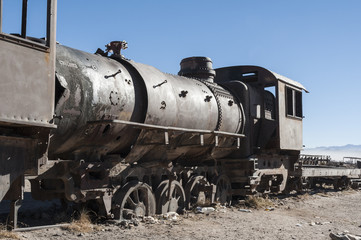 Fototapeta na wymiar Rusty old and abandoned trains at the Train Cemetery (Cementerio de Trenes) in Uyuni desert, Bolivia - South America