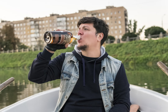 Man on a boat drinks rum