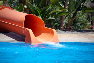 Colorful plastic sliding tube in aqua park.
