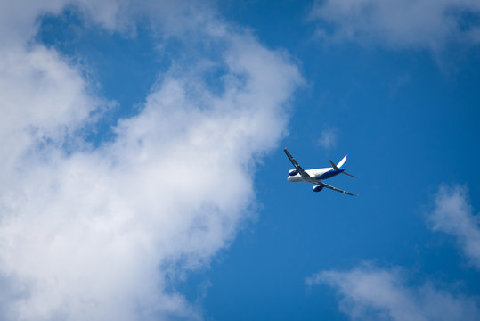 Passenger airplane rising sky after taking off and getting in cloudness.