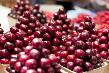 Piles of Red Cherries in a Produce Market