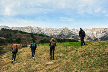 Obraz premium the journey of four Wanderers tourists in the snowy mountains