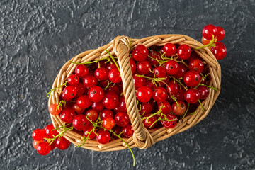 Fresh juicy red currant berries in a wicker basket