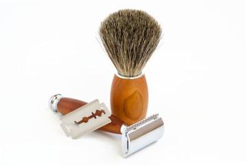 Traditional steel razor with hairy shaving brush isolated in white