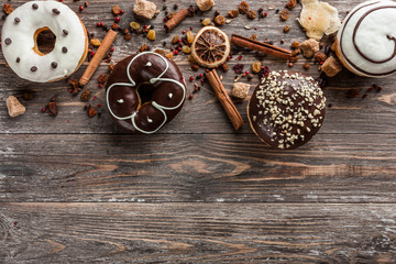 Delicious assorted donuts for a holiday. Top view and copy space, old wood background